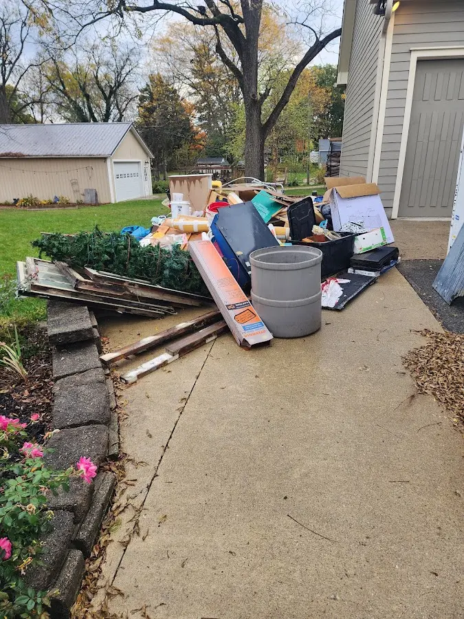 Dumpster being loaded with debris for 12 Yard Dumpster Rental in Everson